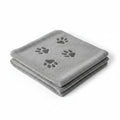 A folded gray microfiber dog grooming towel with three dark gray paw prints, shown on a plain white background.
