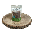 Package of 100 percent natural Nova dog treats on a wooden surface with a white background