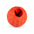 An orange-red textured rubber ball dog toy with a central hole for treats, shown on a plain white background.